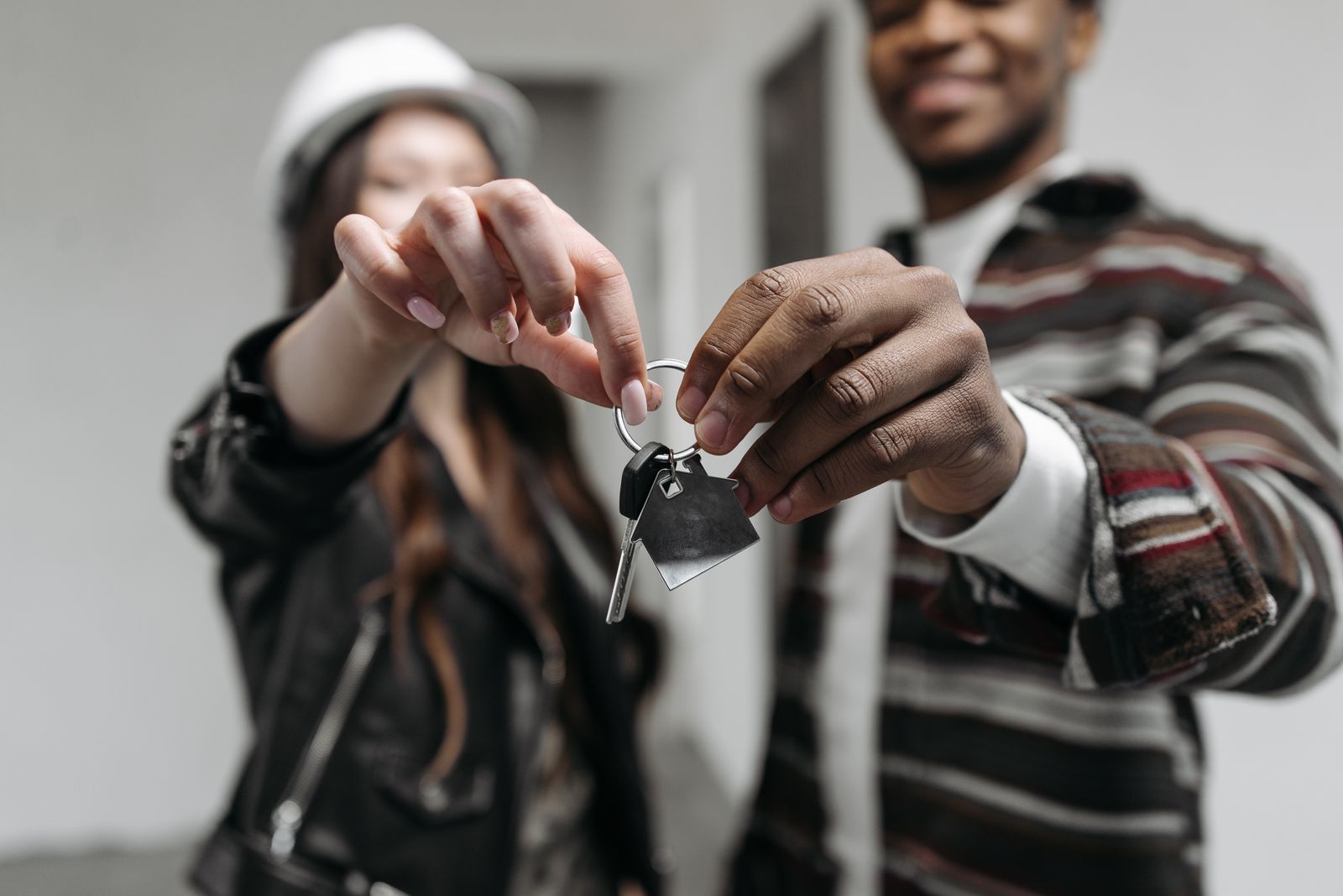 Homeowners holding the keys to the house they bought